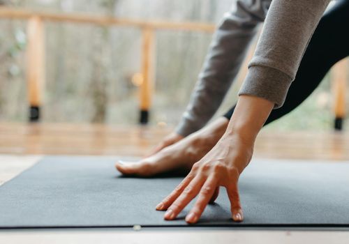 Close-up of feet on a yoga mat, showing balance and stability.